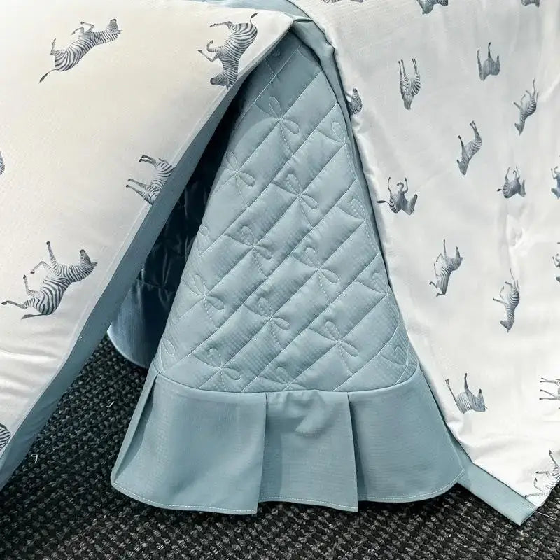 Light blue quilted bed skirt with ruffled hem and diamond stitch pattern in decorbites cool silk summer quilt set