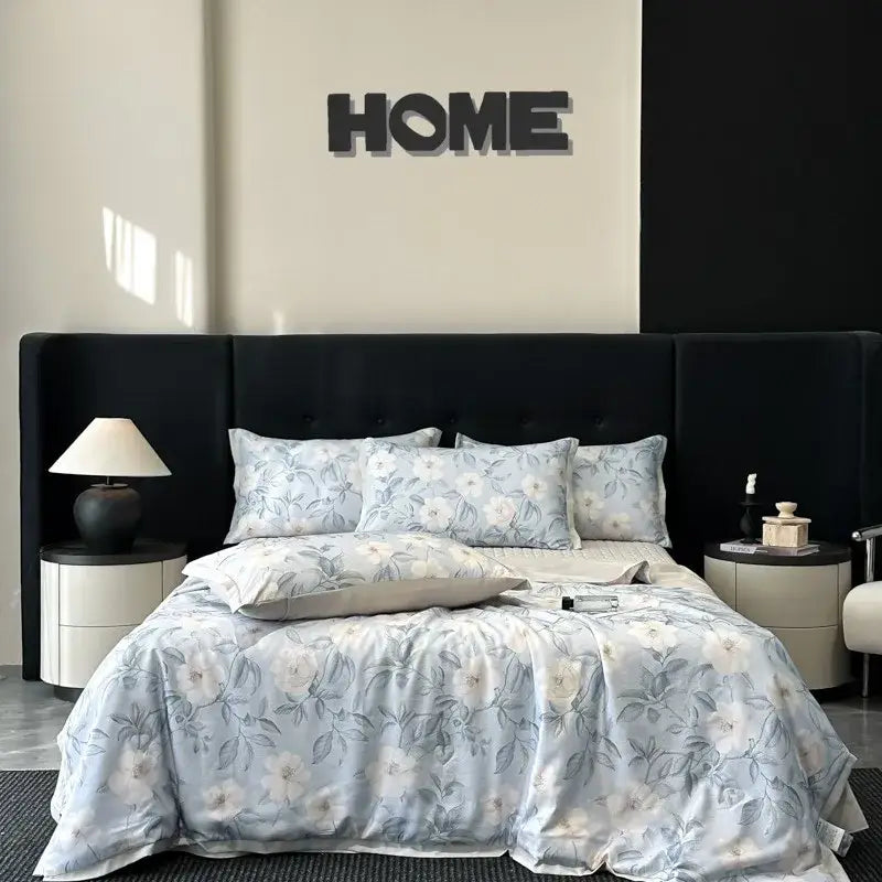 Light blue floral patterned satin quilt set with matching pillows and gray accent pillow by decorbites cool silk summer