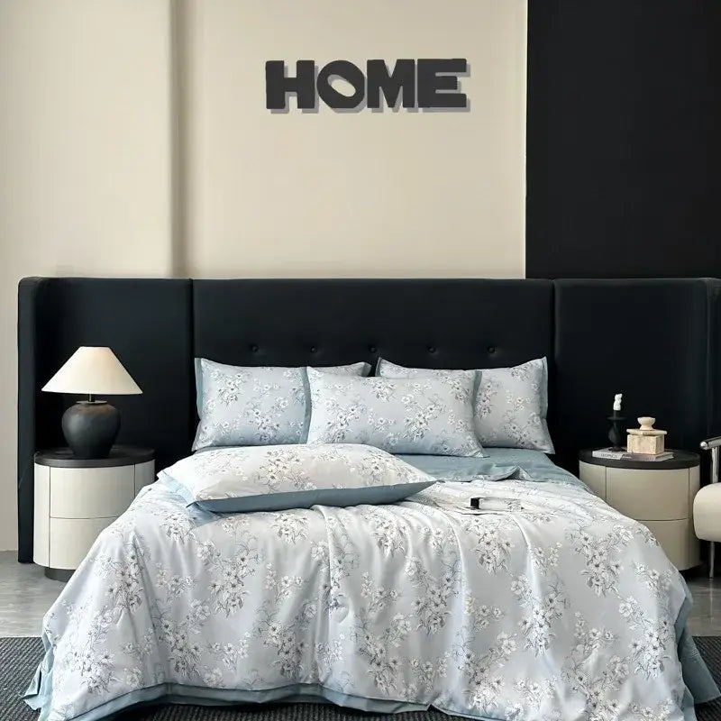 Light blue floral-patterned quilt set with silver embroidery and matching pillow sham from decorbites cool silk summer collection