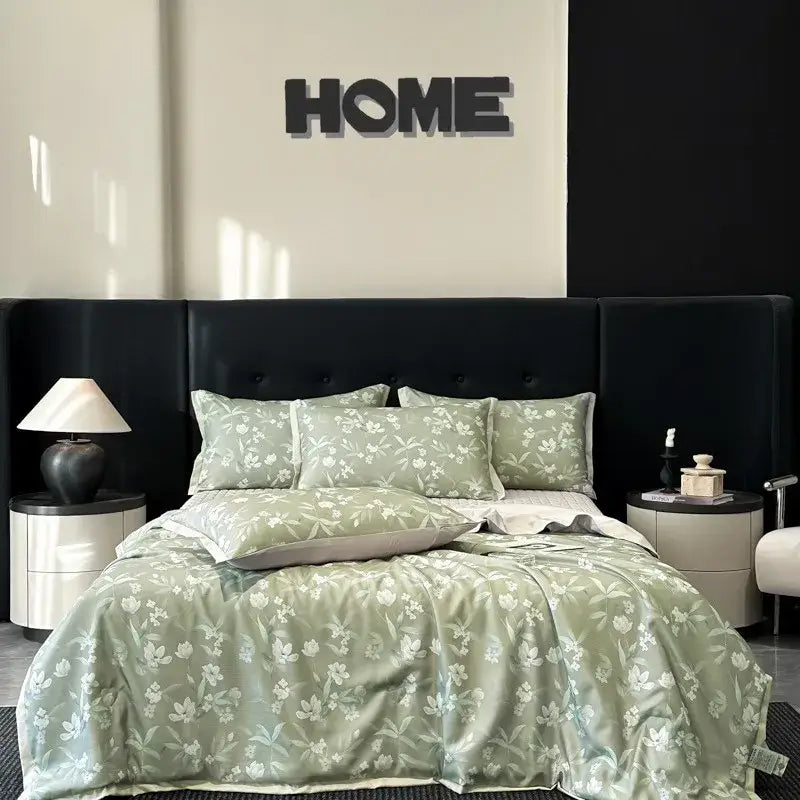 A soft sage green satin quilt set with white floral pattern featuring decorbites cool silk summer bedding