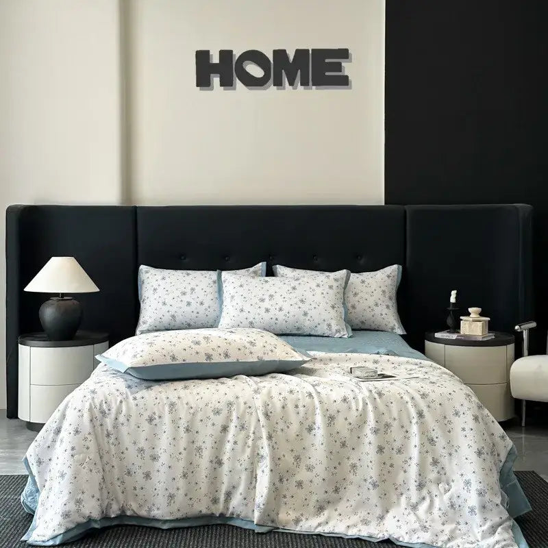 A white zebra print cool silk summer quilt set with a soft white duvet cover featuring gray floral patterns and blue lining