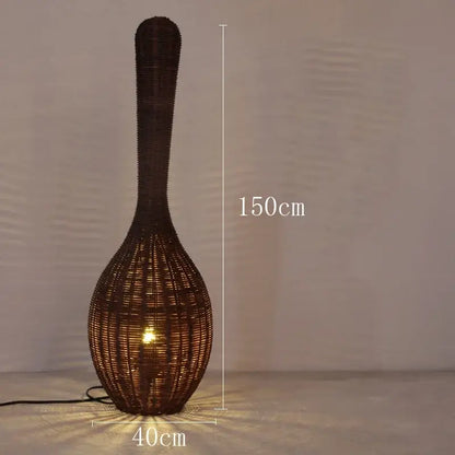 A tall dark brown woven rattan floor lamp with a slender neck and bulbous base for warm living room decorbites bamboo floor lamp
