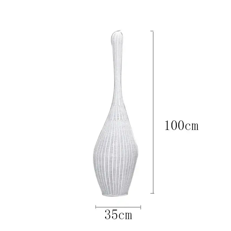 A tall slender white woven vase beside a dark brown bamboo floor lamp for warm living room decorbites bamboo floor lamp