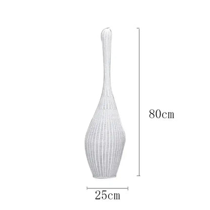 A tall slender white woven vase with flared top and tapered base complements bamboo floor lamp decorbites floor lamp