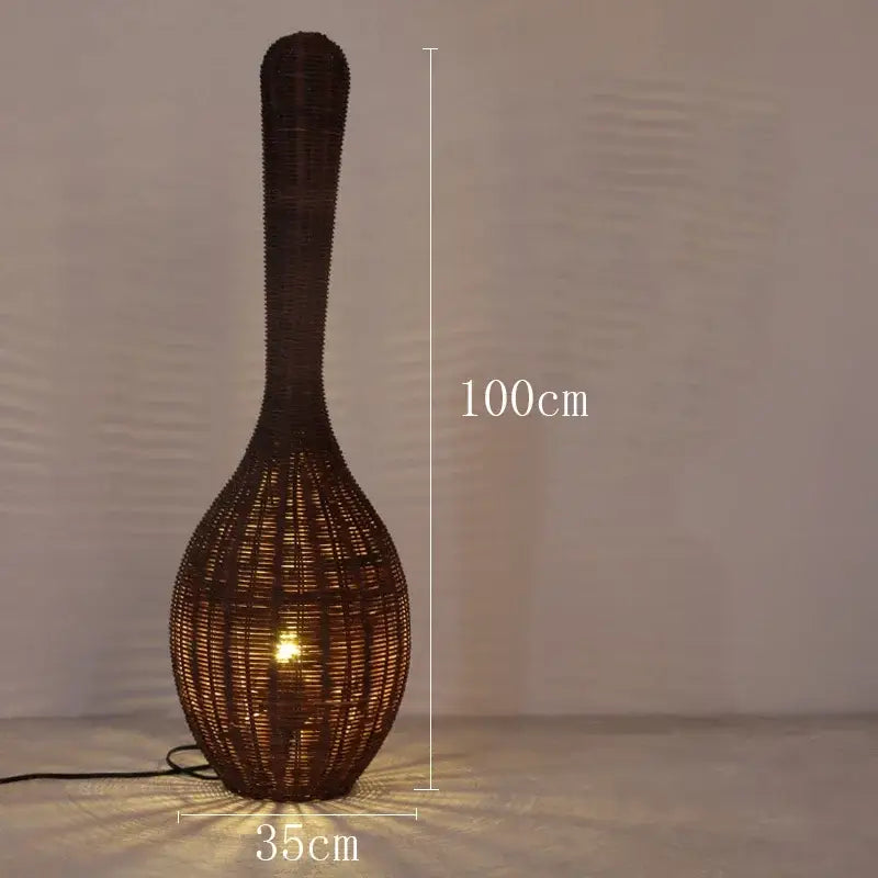 A tall dark brown woven rattan floor lamp with a slender neck and bulbous base for decorbites bamboo floor lamp decor