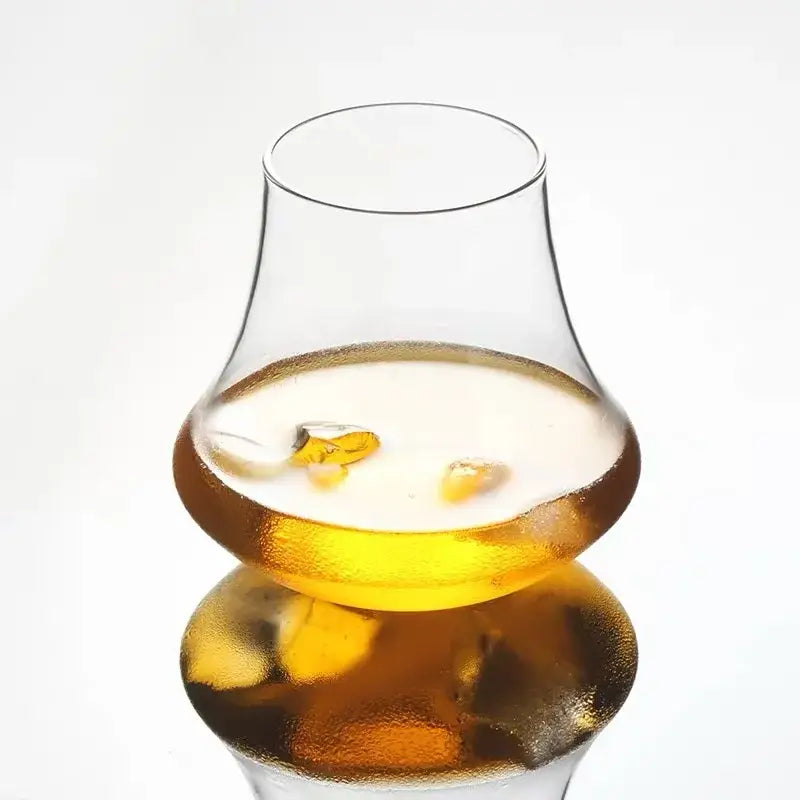 A wind edge decorbites crystal whiskey glass tumbler filled with amber liquid and ice cubes for dining room spirits