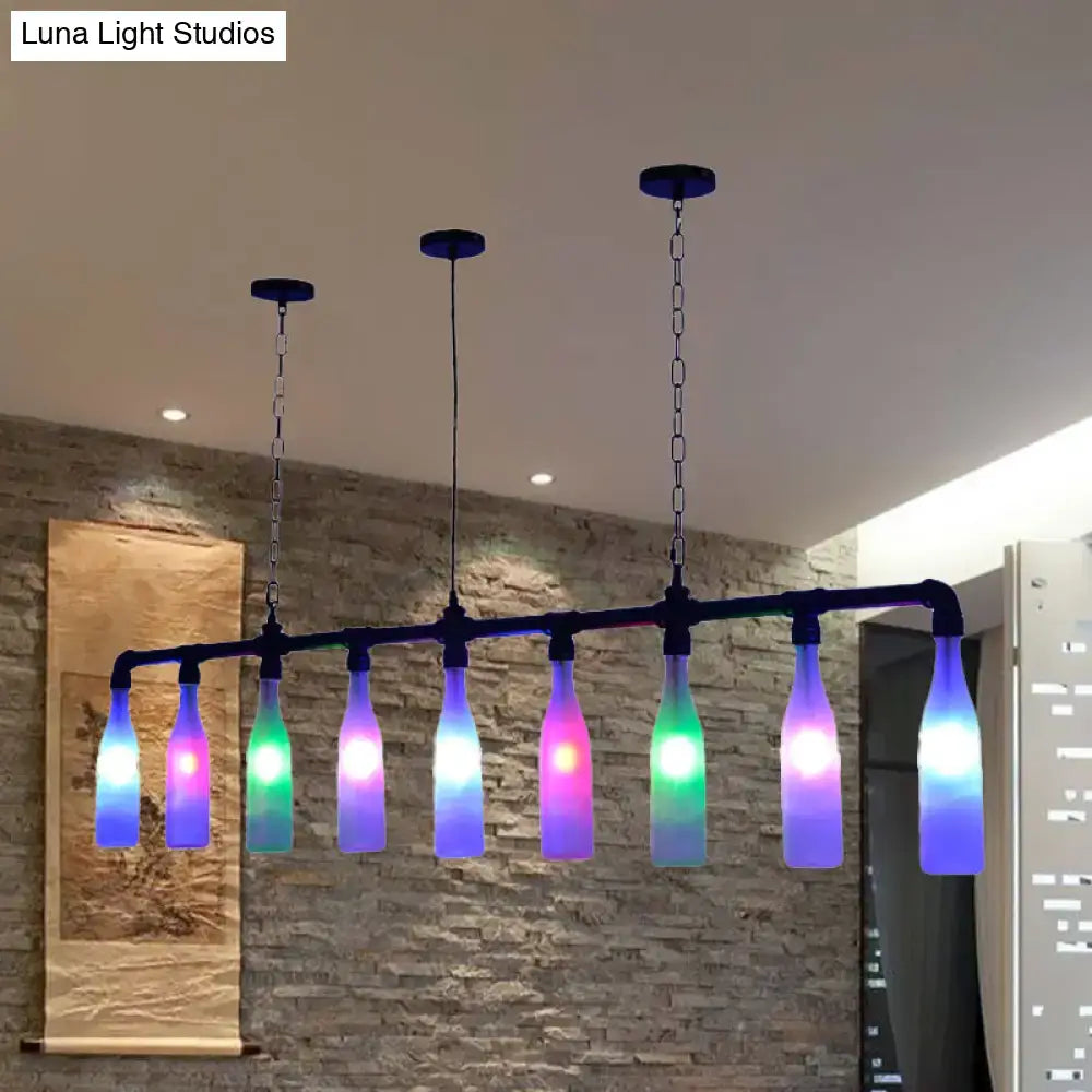 A DecorBites™ Art Deco island pendant light featuring seven colorful glass bottles with rainbow LED lights and black frame