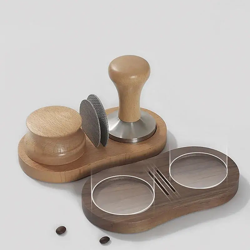 Wooden espresso distributor tamper with light brown handle and stainless steel base on dark wood tray with accessories