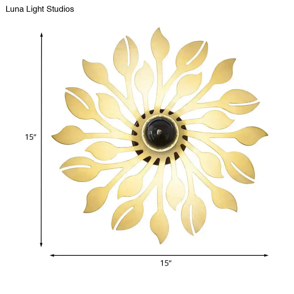 Gold-colored leaf-shaped wooden floral wall lamp with central black bulb housing for bedroom lighting