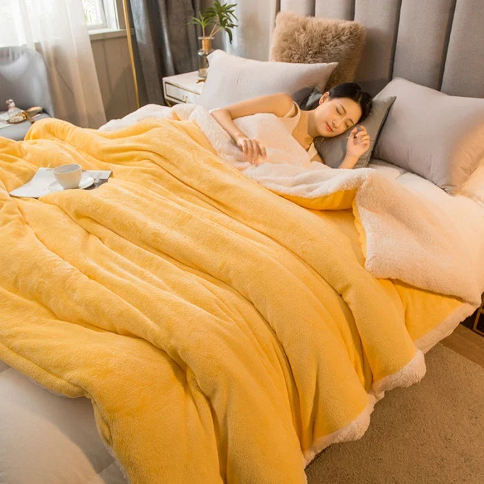 A cozy two-toned yellow and cream wool throw blanket with a soft textured surface for winter bed use