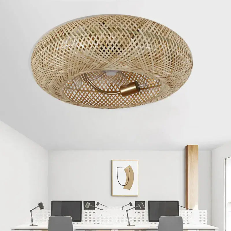 Woven bamboo ceiling fan with retractable blades featuring a circular lattice design and brass bulb holder for bedroom use