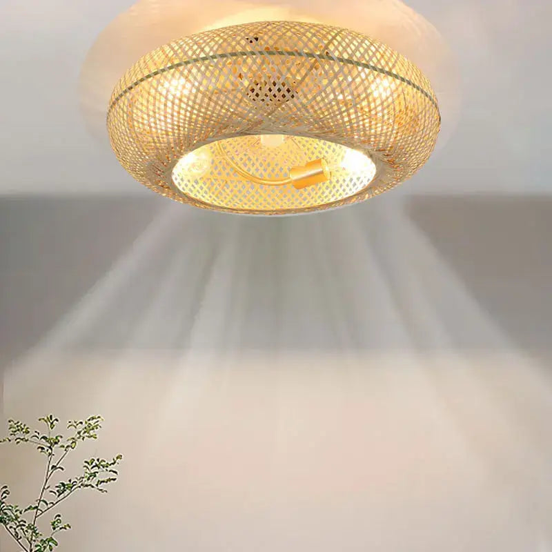 A warm circular woven bamboo ceiling fan with retractable blades and golden accents for bedroom decorbites bamboo ceiling