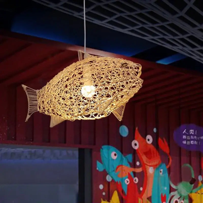 Golden intricately woven rattan bamboo fish art pendant light with glowing bulb for kitchen or living room decorbites bamboo fish