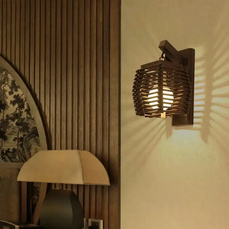 Dark wooden bamboo wall sconce light with woven lattice design casting warm light for corridor and cafe use