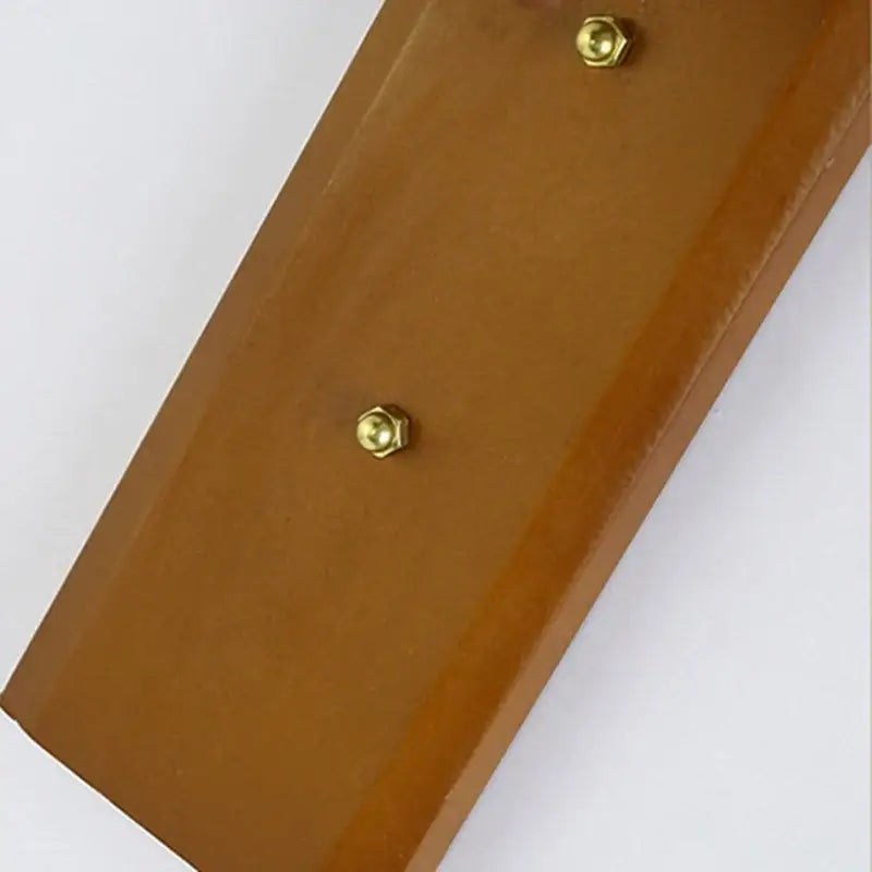 Brown leather back panel with brass bolts of woven bamboo wall sconce light in warm wood tone for corridor and cafe