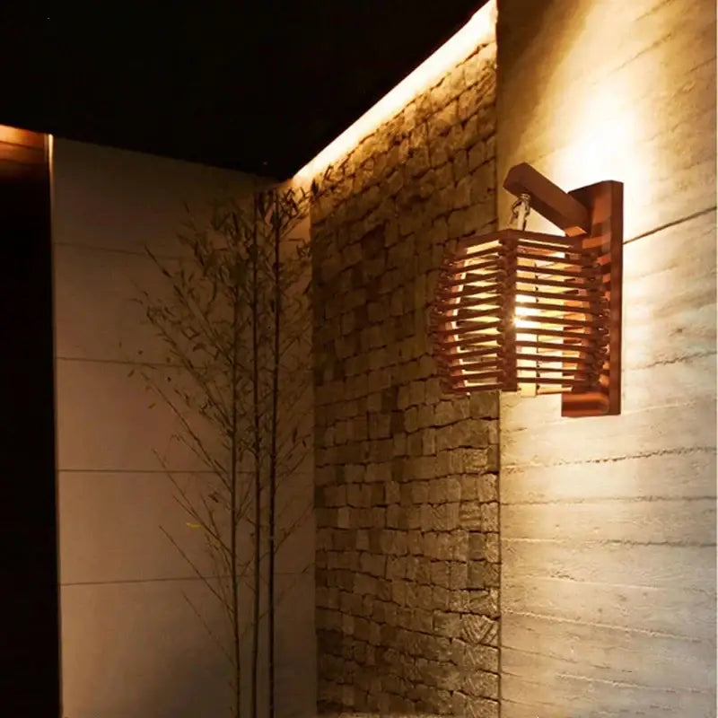 Warm-toned woven bamboo wall sconce light with rustic wooden bracket ideal for corridor and cafe lighting