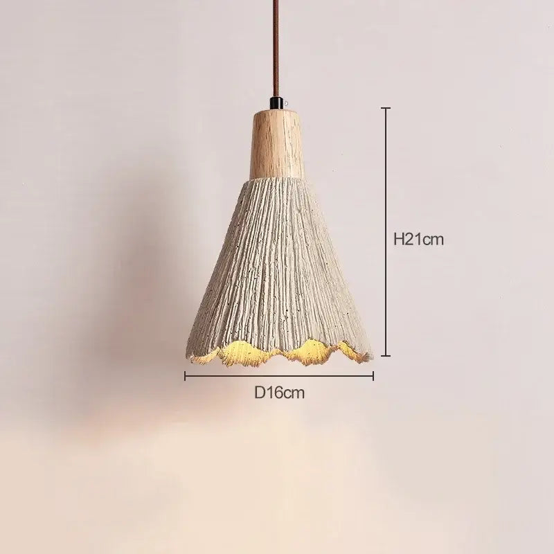 A modern pendant light with a textured light gray concrete shade natural wood top and golden scalloped edge decorbites designer pendant