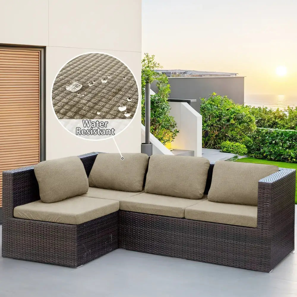 Dark brown woven wicker l-shaped modular sofa with beige fabric cushions and cream cover for outdoor protection