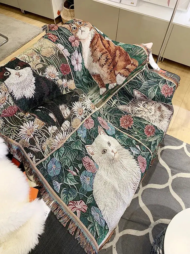 A cozy green woven oil painting blanket featuring embroidered cats and floral design with fringed edges for decorbites cat oil decor