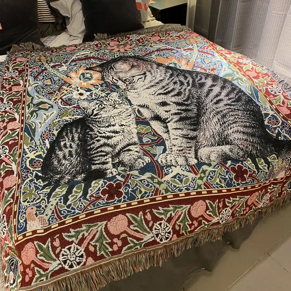 A woven colorful cat oil painting blanket featuring two tabby cats in vibrant floral decor with fringed earthy edges