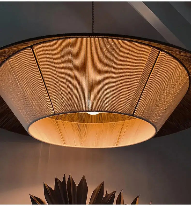 Warm-toned circular pendant lamp with woven bamboo shade and dark wooden rim from decorbites handmade hemp rope collection