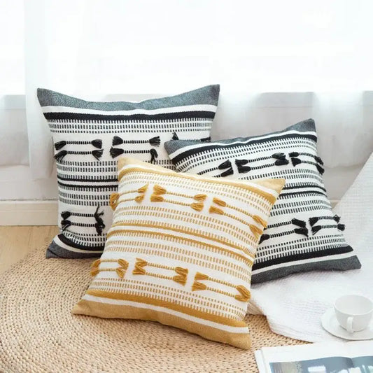 Three decorative woven geometric tassels cushion covers in black white and mustard yellow for living room decorbites decor