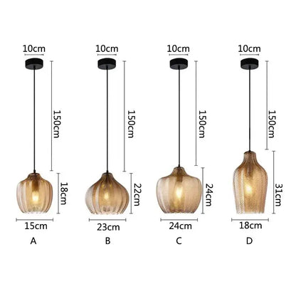 Four nordic style pendant lights with textured amber glass shades and black metal fixtures for kitchen and dining room