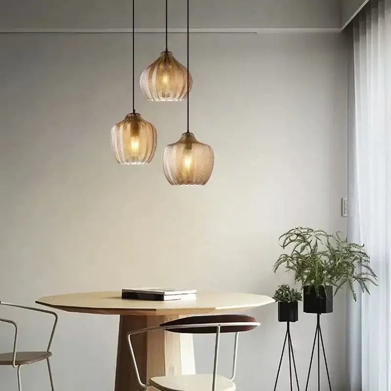 Three warm-toned ribbed woven gold glass pendant lights for kitchen and dining room ceiling installation