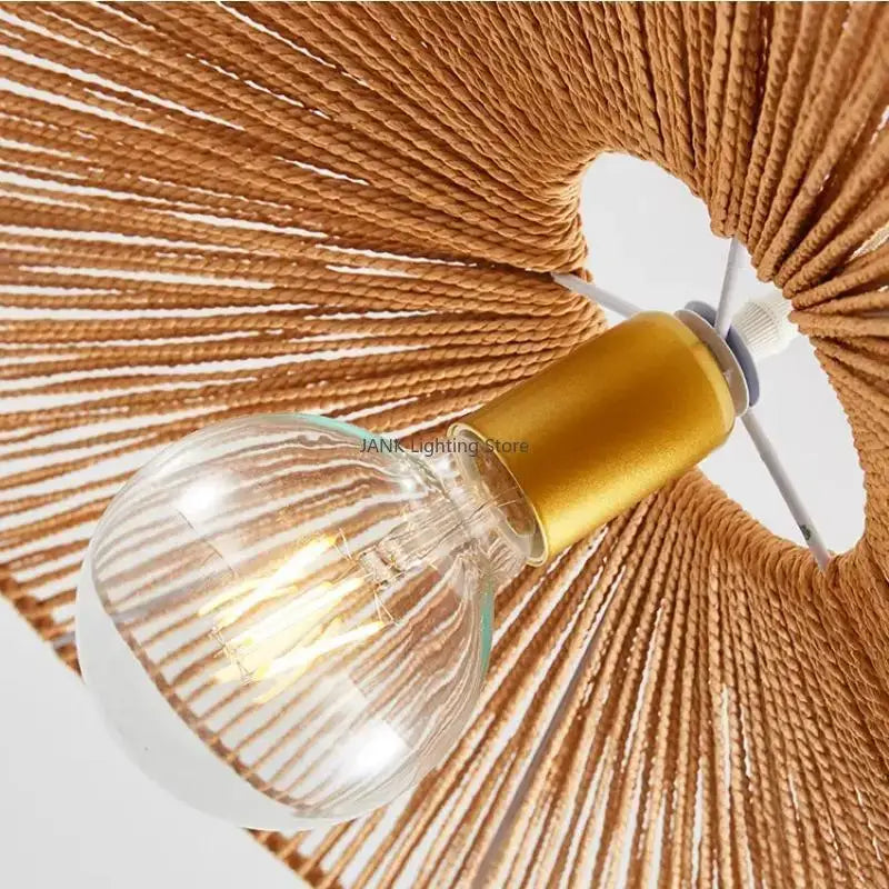 Warm-toned woven hemp rope pendant light with gold-finished bulb holder and clear glass bulb for living room decorbites hemp rope