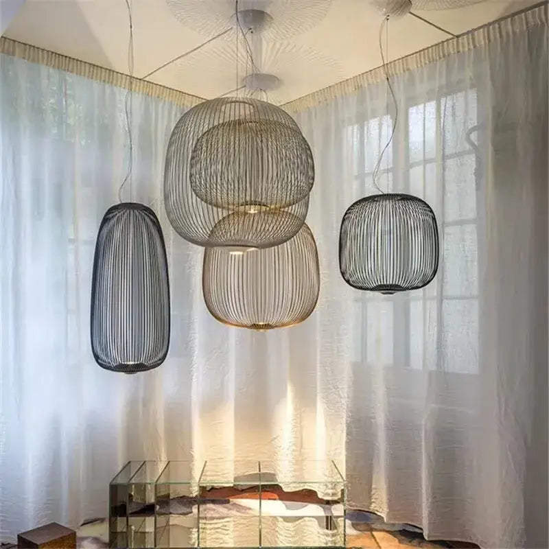 Sleek modern pendant light with woven wireframe and polished chrome finish hanging in a dining room setting
