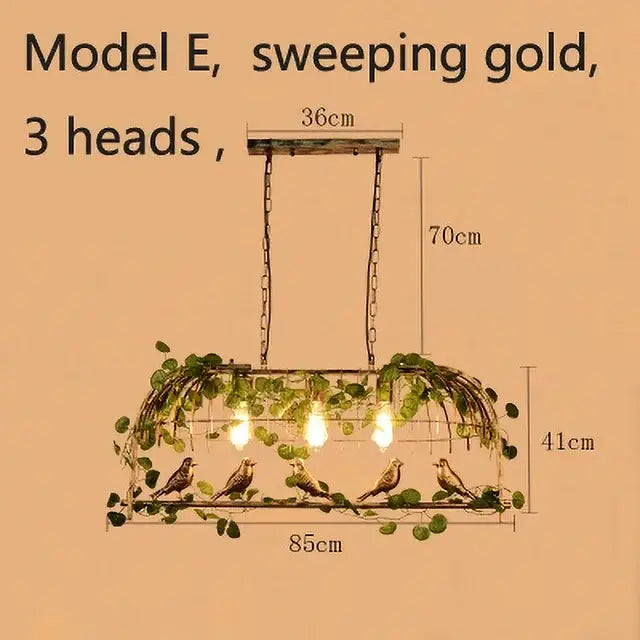 Sweeping gold wrought iron birdcage pendant lights with three heads, rustic metal frame, green ivy, and perched birds