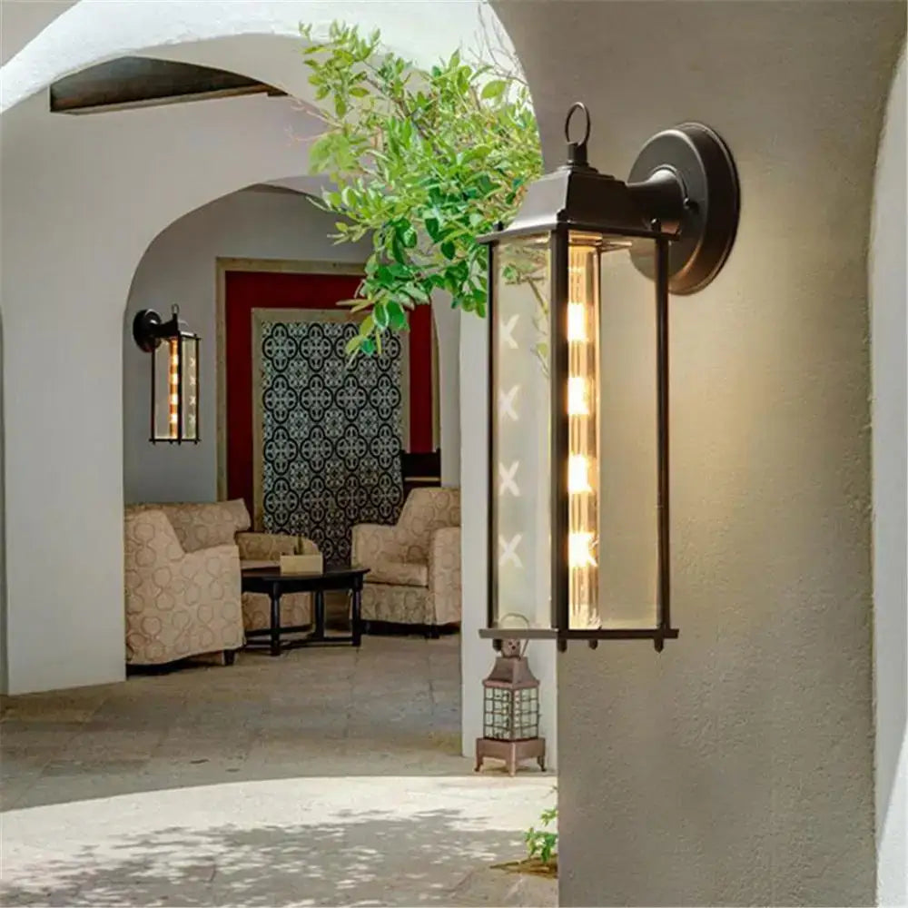 Black wrought iron wall lantern with clear glass panels and vertical led lights decorbites black finish outdoor light