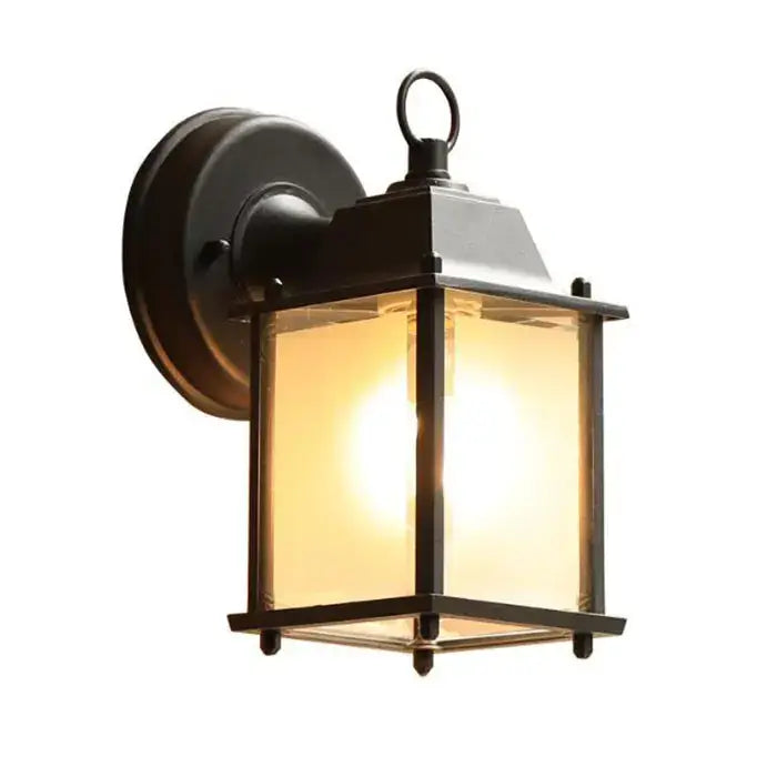 Black wrought iron wall lantern with black finish clear glass panels and warm glowing light for outdoor porch decorbites black finish