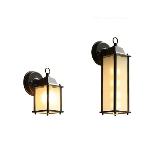 Black wrought iron wall lantern with frosted glass panels and warm lighting for outdoor porch decorbites black finish