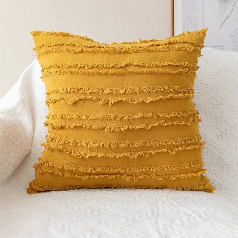 A mustard-yellow pillow cover with horizontal frayed stripes made of soft fabric for decorbites daisy floral embroidery