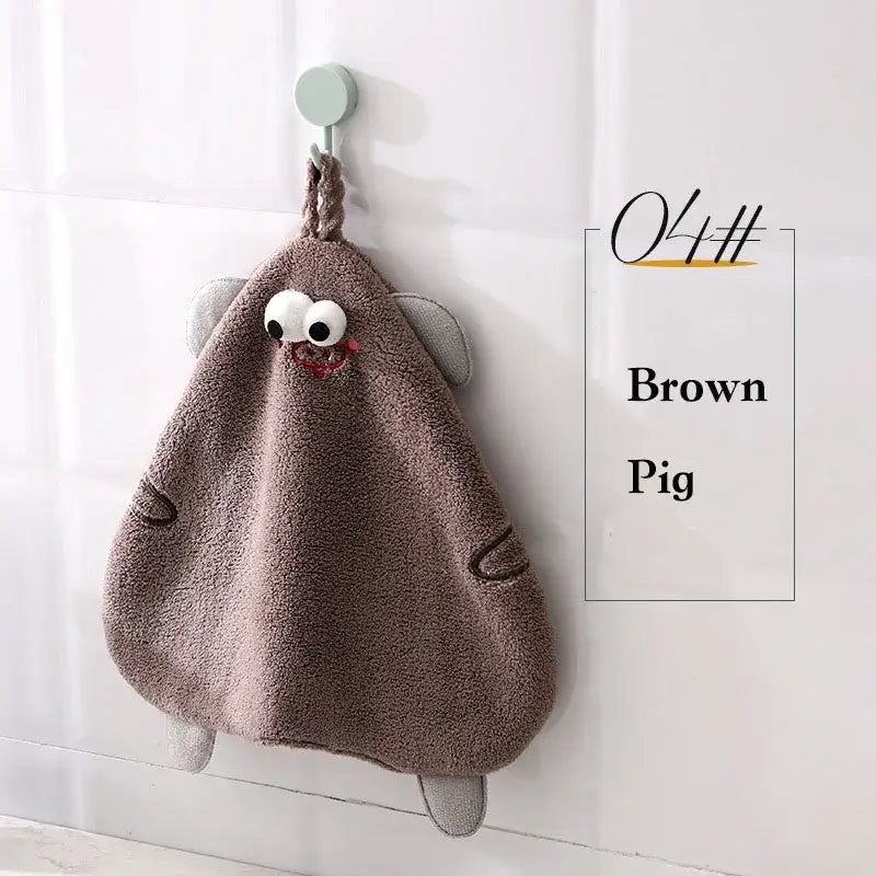 Brown plush pig-shaped hand towel with embroidered eyes and stitched details from decorbites cartoon animal hand collection