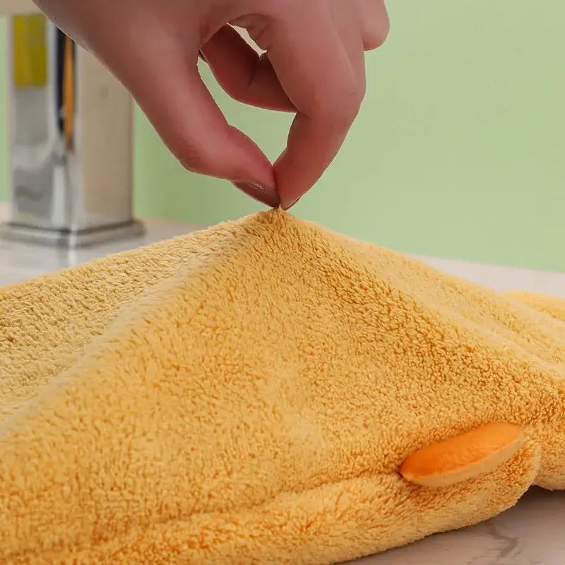Yellow plush hand towel with soft textured surface and orange circular detail from decorbites cartoon animal hand collection