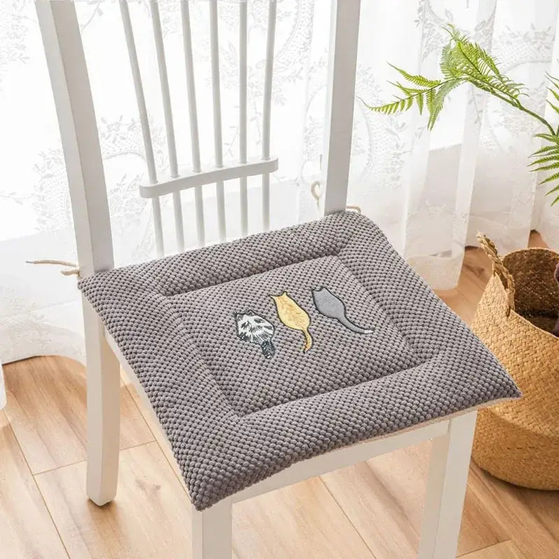 Gray textured seat cushion with yellow and black decorbites cartoon embroidered cat designs for dining room use