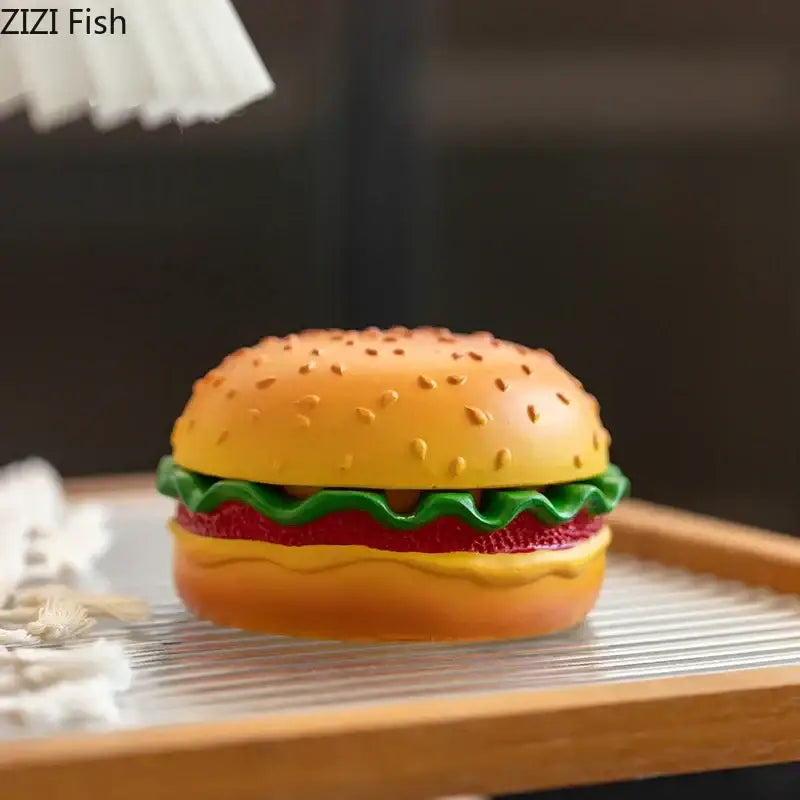 Yellow and green cartoon burger ashtray made of glossy plastic with layered lettuce tomato and cheese for office decor