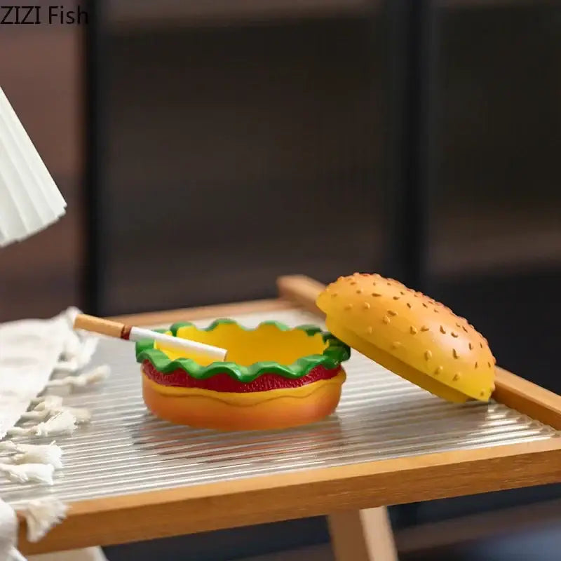 Yellow and green plastic cartoon burger ashtray with sesame seed textured lid for office table decorbites cartoon burger decor