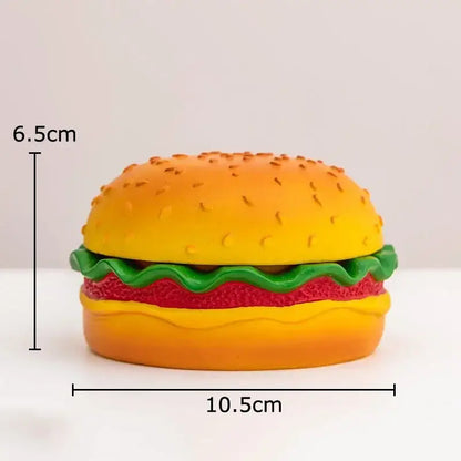 A vibrant yellow and green cartoon burger ashtray shaped like a plastic hamburger for office table decor