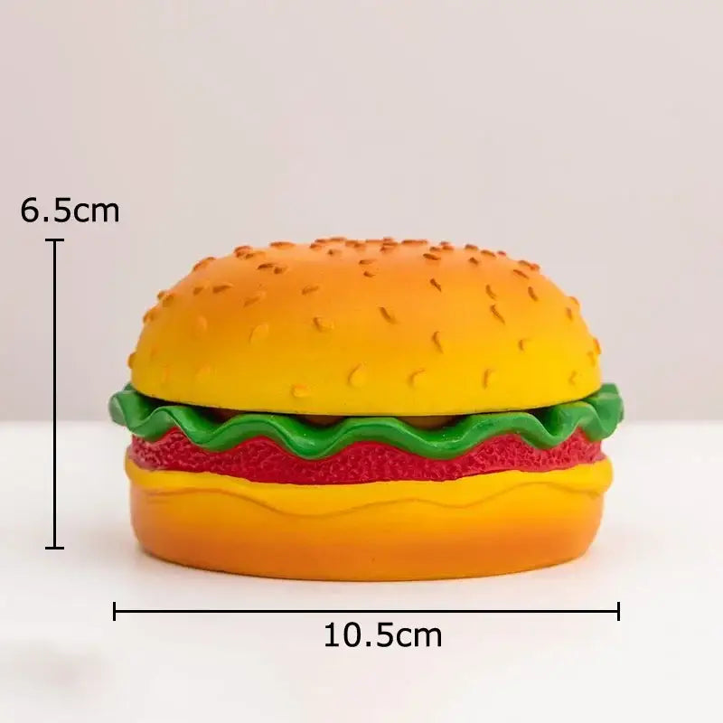 A vibrant yellow and green cartoon burger ashtray shaped like a plastic hamburger for office table decor