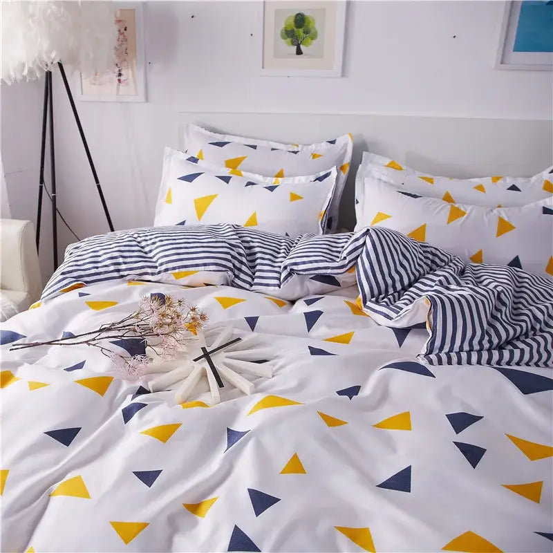 White duvet cover and pillowcases with a yellow and navy blue triangle pattern in decorbites cartoon printed bedding set