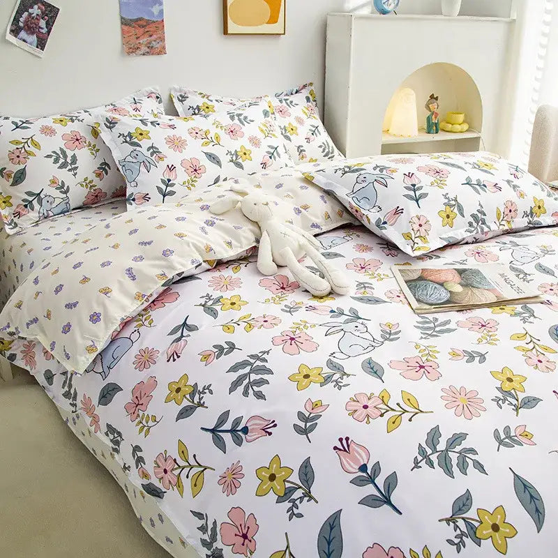 Pastel floral and bunny cartoon printed cotton bedding set with soft pink yellow and purple blossoms by decorbites