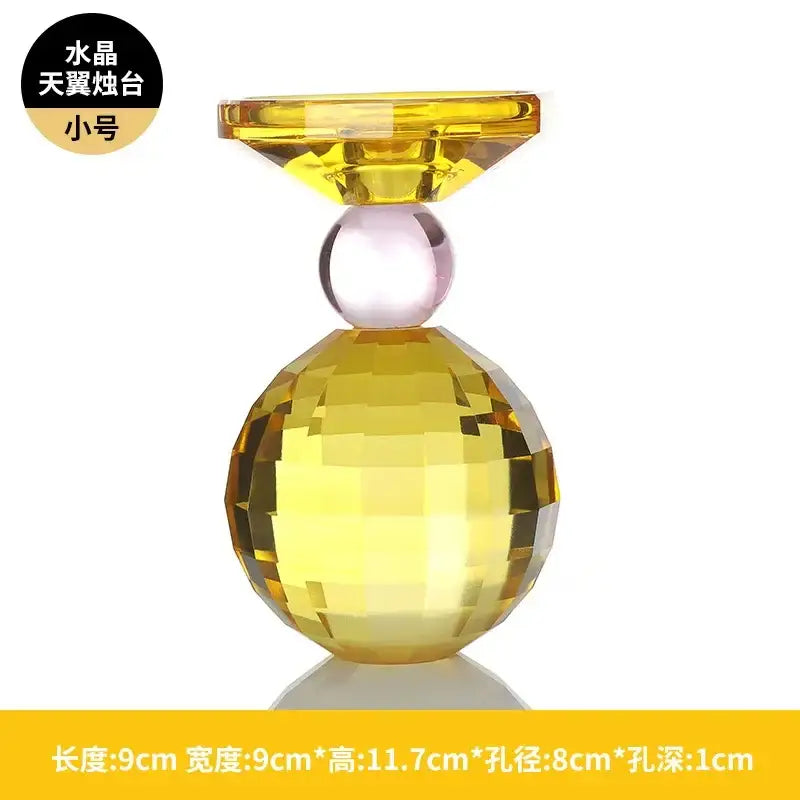 Yellow and pink crystal candle holder with faceted spherical base and translucent top for dining room centerpiece