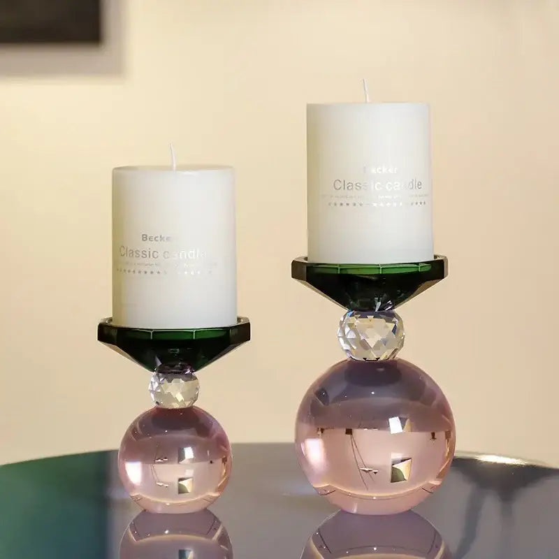 Two elegant crystal candle holders with dark green hexagonal bases and pink spherical accents for dining room centerpiece