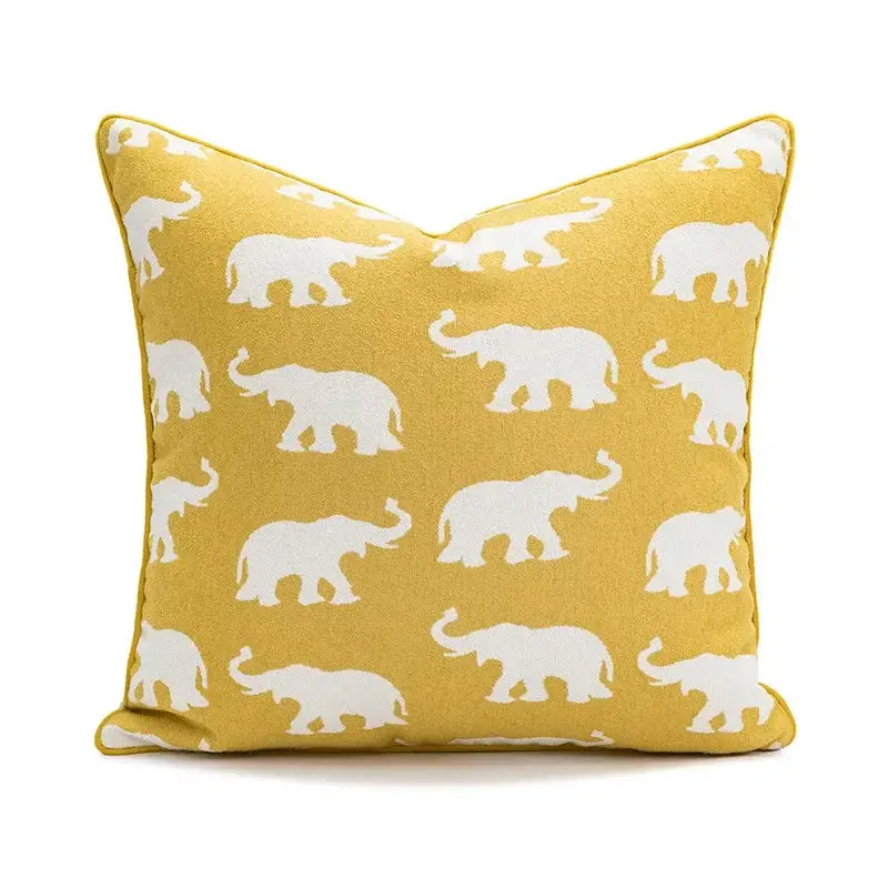 Yellow cushion cover with white geometric elephant silhouettes for living room decor by decorbites geometric elephant