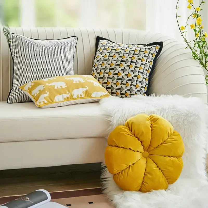A plush mustard-yellow velvet flower cushion on white faux-fur throw complements decorbites geometric elephant cushion cover decor