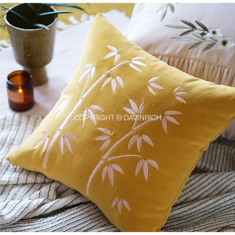 Mustard-yellow velvet throw pillow cover with white bamboo embroidery for bedroom decor and home accents