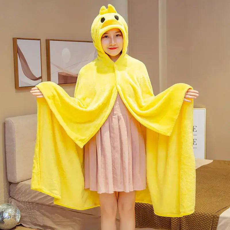 Bright yellow plush hooded cape blanket with soft fluffy texture and embroidered chick eyes for bedroom and office warmth